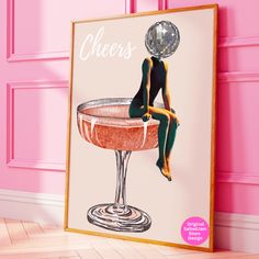 a poster with a woman sitting on top of a cocktail glass in front of a pink wall