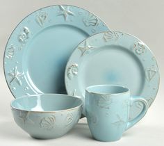 a set of blue dishes and cups on a white background