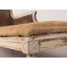 an old wooden bed frame with burlocked upholstered headboard and foot board