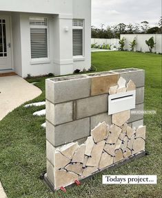 there is a cement block that has been placed on the grass in front of a house