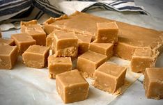 pieces of caramel fudge sitting on top of a white plate