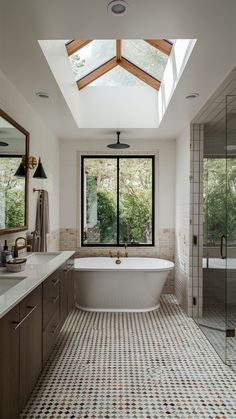 a large bathroom with a skylight above the bathtub