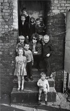 black and white photograph of children standing on steps