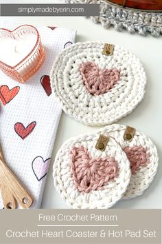 Two Crochet Heart Coasters and a Heart Hot Pad in pink and cream, displayed with a dishtowel with hearts on it, a pink heart shaped candle, and mini spatulas in pink and red. Valentine Crochet Ideas Simple, Valentines Day Crochet Ideas, Valentines Day Crochet Patterns Free, Crochet Coaster Set, Valentine Crochet Patterns Free, Valentines Day Crochet, Crochet Heart Hot Pad, Heart Coasters Crochet, Crochet Heart Coaster