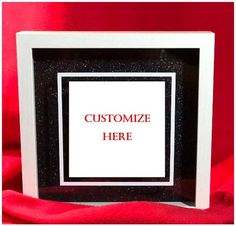 a black and white frame with the words customize here in red lettering on it