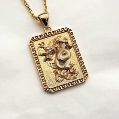 men's korean dragon necklace pendant 2 made in real 14k solid gold or real 18k solid gold the korean dragon with exquisite details is on this pendant. - the pendant height is 26mm without the bail. - model wears a 14k 1.7mm 50cm chain. - materials: real 14k solid gold, real 18k solid gold - free shipping on all orders via fedex! - designed by carre d'or - made in south korea 14k gold dragon pendant necklace 2 weight pendant only 7.84g (±3%) with 2.1mm 42cm chain 13.80g (±3%) with 2.4mm 42cm chain 15.67g (±3%) with 3.0mm 42cm chain 19.42g (±3%) 18k gold dragon pendant necklace 2 weight pendant only 9.34g (±3%) with 2.1mm 42cm chain 15.74g (±3%) with 2.4mm 42cm chain 17.75g (±3%) with 3.0mm 42cm chain 21.78g (±3%) Dragon Design Pendant Amulet Jewelry, Gold Dragon Design Round Pendant Jewelry, Gold Round Pendant With Dragon Design, Dragon Design Amulet Necklace, Yellow Gold Dragon Pendant Jewelry, Yellow Gold Dragon Design Pendant Jewelry, Mens Necklace Gold, Korean Dragon, Men's Necklace Gold