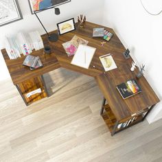 a computer desk sitting on top of a hard wood floor next to a white wall