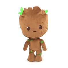 a small stuffed toy with green leaves on it's head and legs, sitting in front of a white background