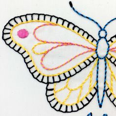 an embroidered butterfly is shown on a white surface