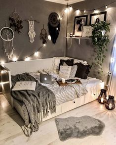 a bed room with a neatly made bed and lots of lights on the wall above it