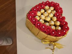 a heart shaped box filled with lots of chocolates