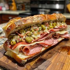 a ham and olive sandwich on a cutting board