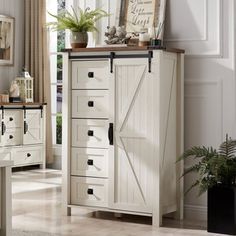 a white cabinet with doors and drawers in a room