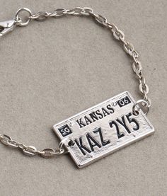 a close up of a bracelet with a name tag on it