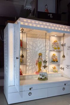 a white display case filled with lots of figurines and lights on top of it