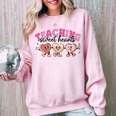 Celebrate the season of love with our exclusive Valentines Day Teacher Sweatshirt! 🎉🍎 Show your passion for teaching and spread the love in style with our Teaching Sweethearts Teacher Shirts.  Perfect as a thoughtful Teacher Valentines Day Gift, our Love Teacher Shirt is a unique way to express appreciation for the educators who make a difference every day. 💝📚 Why choose our Valentines Day Shirt? 🌟 It's not just a piece of clothing; it's a statement of love and gratitude. Crafted with care Valentines Day Teacher, Teacher Valentines, Custom Coffee Cups, Season Of Love, Love Teacher, Teacher Sweatshirt, Valentines Day Shirt, Favorite Teacher, Gift Love