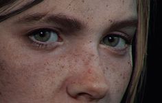 a woman with freckles on her face looking at the camera