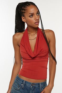 Sleek Silence + Noise top in a halter neckline style. Designed in a soft & stretchy knit featuring a plunging v-neckline with cowl draping and finished with an open back. Find this better-than-basic halter top only at Urban Outfitters. Features Silence + Noise Coyote cowl neck top Cropped halter top Soft and stretchy knit Plunging v-neckline with halter strap Draping on the bust and v-hem bodice Open back Sleeveless Slim body-skimming fit Cropped length Easy pull-over style UO exclusive Content Halter Tops Outfit, Cropped Halter Top, Neck Halter Top, Layered Cami, Baby Graphic Tees, Halter Strap, Cowl Neck Top, Halter Crop Top, Top Cropped