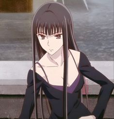 a woman with long black hair standing in front of a building and holding her hands on her hips