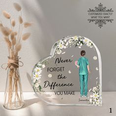 a heart shaped glass plaque with the words never forget the difference you make