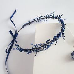 a headband with blue beads on top of a piece of paper