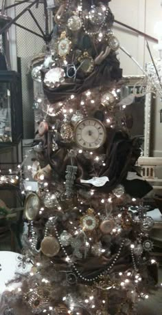 a christmas tree decorated with clocks and other ornaments