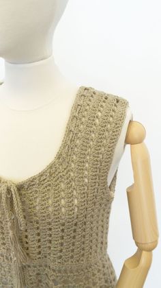 a white mannequin wearing a knitted top