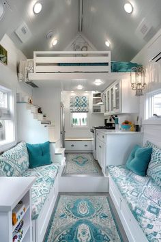 the interior of a tiny home with blue and white decor