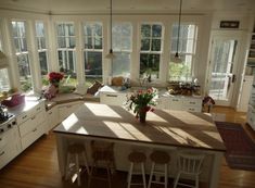 the sun shines through the windows in this kitchen