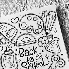 back to school coloring book with black and white doodles on the cover, next to a lace doily