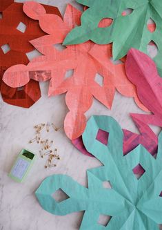 paper snowflakes are laid out on a table