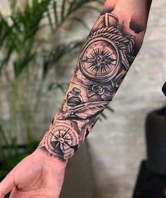 a man's arm with a compass and other things on it, all around him