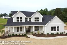 a large white house with black roof and windows