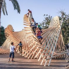 people are riding on the wooden structure that looks like a bird's nest, while others ride their bikes