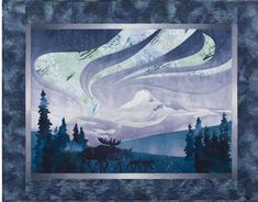 a quilt with an image of the northern sky and mountains in it, as well as two deers