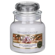 yankee candle jar with an image of a fountain in the center and lights behind it