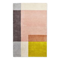 an area rug with different colors and shapes on the floor, including pink, grey, yellow