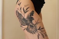 a woman with a bird tattoo on her arm