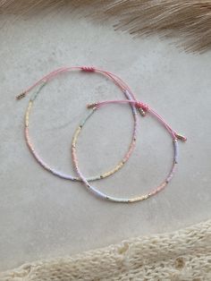 These beautiful and minimalist bracelets are made with glass japanese miyuki beads size 11 and high quality pink nylon cord that does not tarnish, does not break and is waterproof. It's pastel multicolor armband with silver pearls. This family set include 2 bracelets. One for mother and the second one (it is the same but smaller) for daughter. These bracelets are perfect for the moms and daughters who want to feel close even when they're apart. They are tiny, delicate, filigree and very comfortable to wear. The bracelets are adjustable thanks to a macrame slide knot.  For mom It is 15 cm when fully tightened and 28 cm when expanded. For daughter It is 13 cm when fully tightened and 22 cm when expanded. A bracelet for a daughter will be good for the age of 4 to 7 years but first please meas Pastel Colorful Beads Bracelets As Gift, Pastel Colorful Beads Bracelet As Gift, Pastel Bracelets With Colorful Beads For Gift, Adjustable Pink Braided Bracelet With Colorful Beads, Pink Friendship Bracelet With Adjustable Cord, Adjustable Pastel Bracelets With Round Beads, Pastel Beaded Bracelets As Gift, Pastel Beaded Bracelets Gift, Pastel Beaded Bracelets For Gift