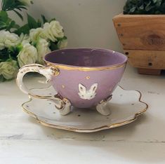 a cup and saucer sitting on top of a table