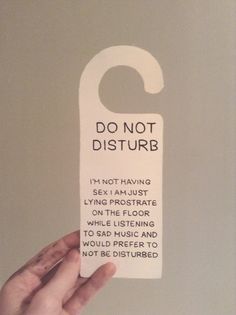 a person holding up a sign that says do not disturb