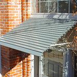 an orange brick building with a metal awning