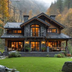 a large house with lots of windows on the front and side of it in the woods