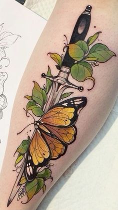 a woman's leg with a butterfly tattoo on it