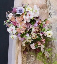 a bride holding a bouquet of flowers in her hands