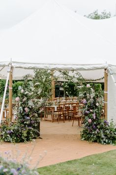 an outdoor tent set up with tables and chairs