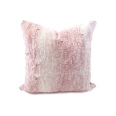 a pink and white pillow on a white background