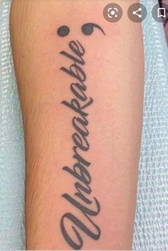 a tattoo with the word's name written in cursive writing on it