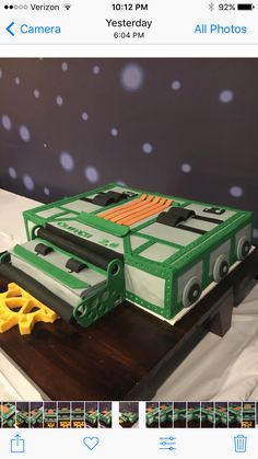 a cake made to look like a construction vehicle and some scissors on a wooden cutting board