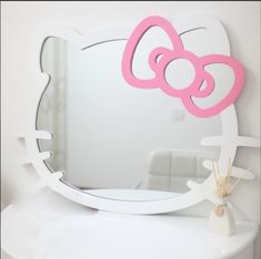 a hello kitty mirror sitting on top of a white table